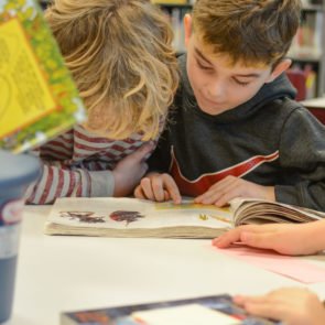 Students reading a book together